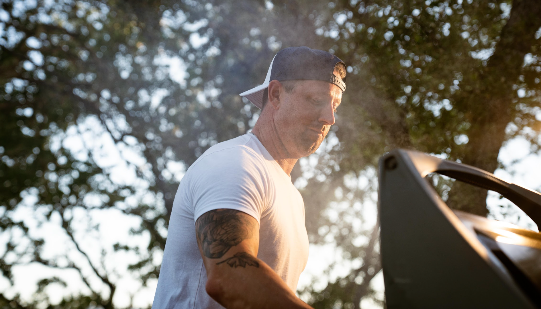melin fam member Alex Belew cooking on a grill