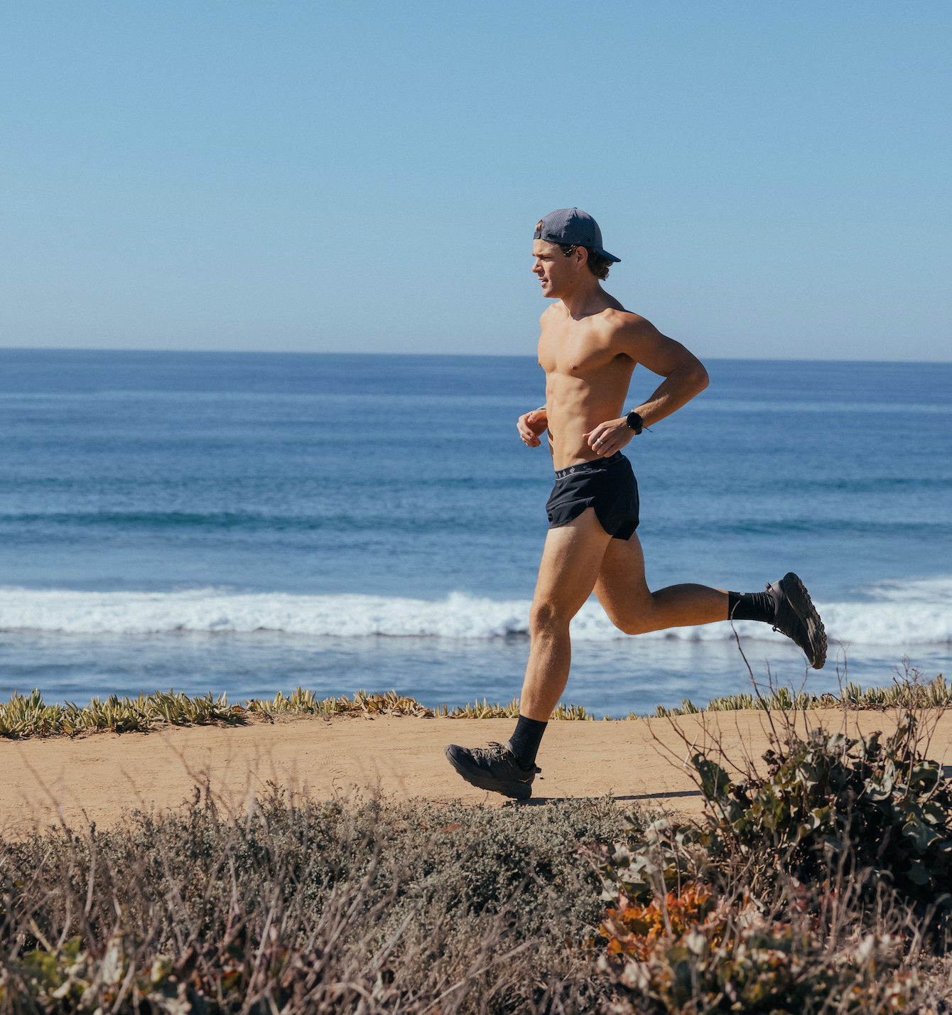 Alec Merlino running and wearing a melin hat